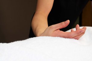 person's hand performing remedial massage