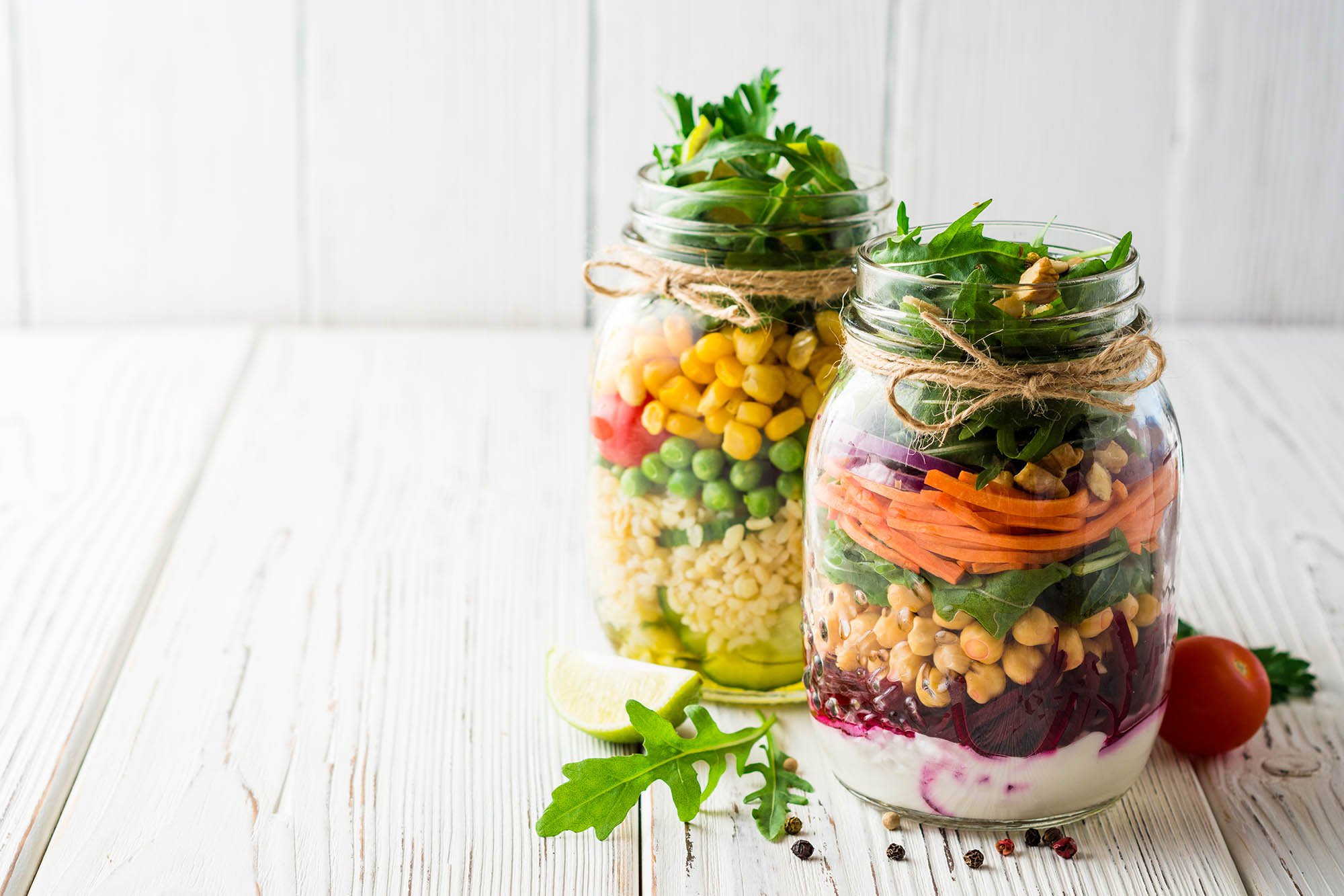 jars with salad ingredients layered inside