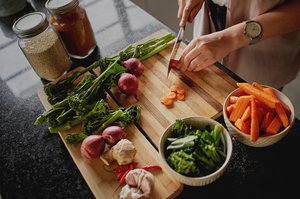 Female hands cutting vegetables in a modern kitchen